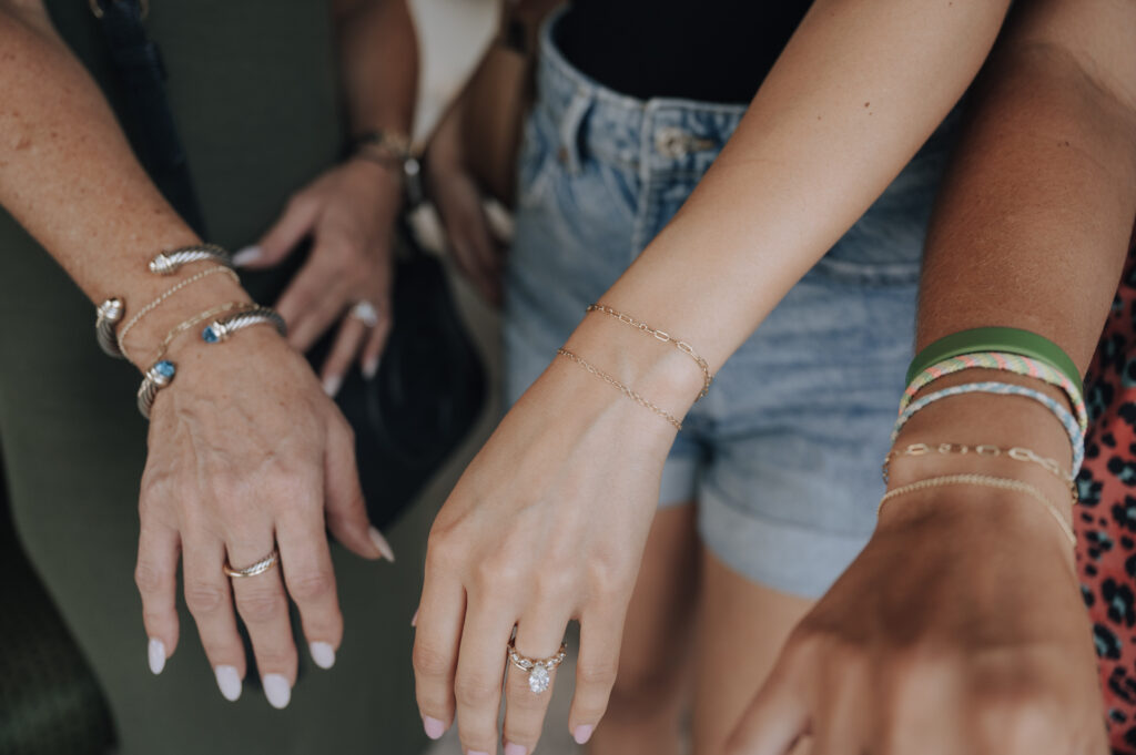 Girls getting permanent jewelry in The Woodlands at a pop-up event